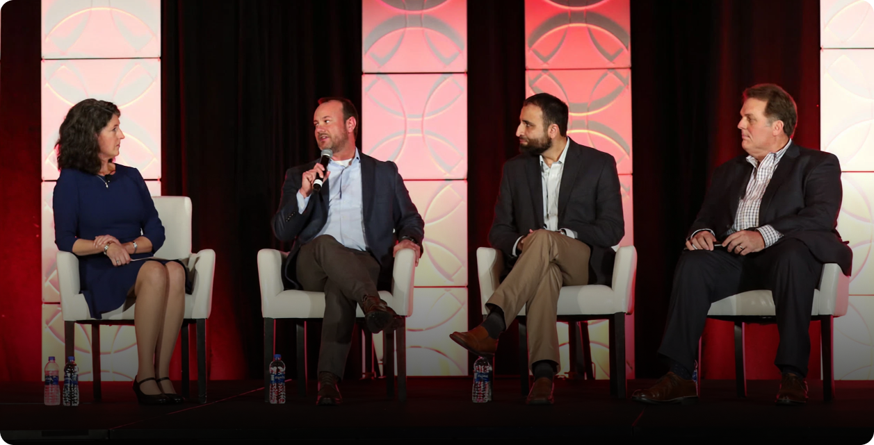 UnifyWell leaders speaking on a conference panel