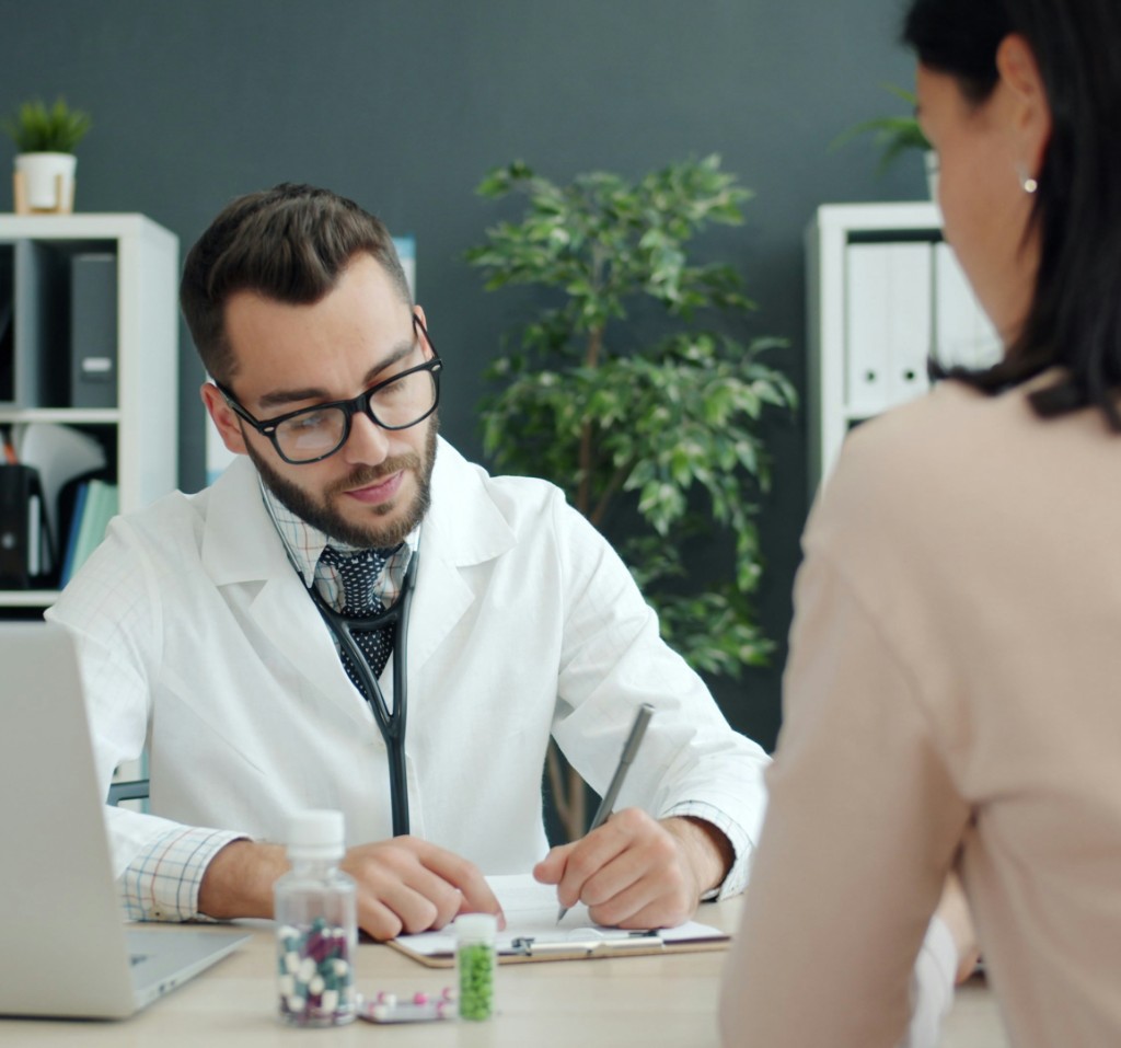 Clinician consulting with a patient during an in-person visit